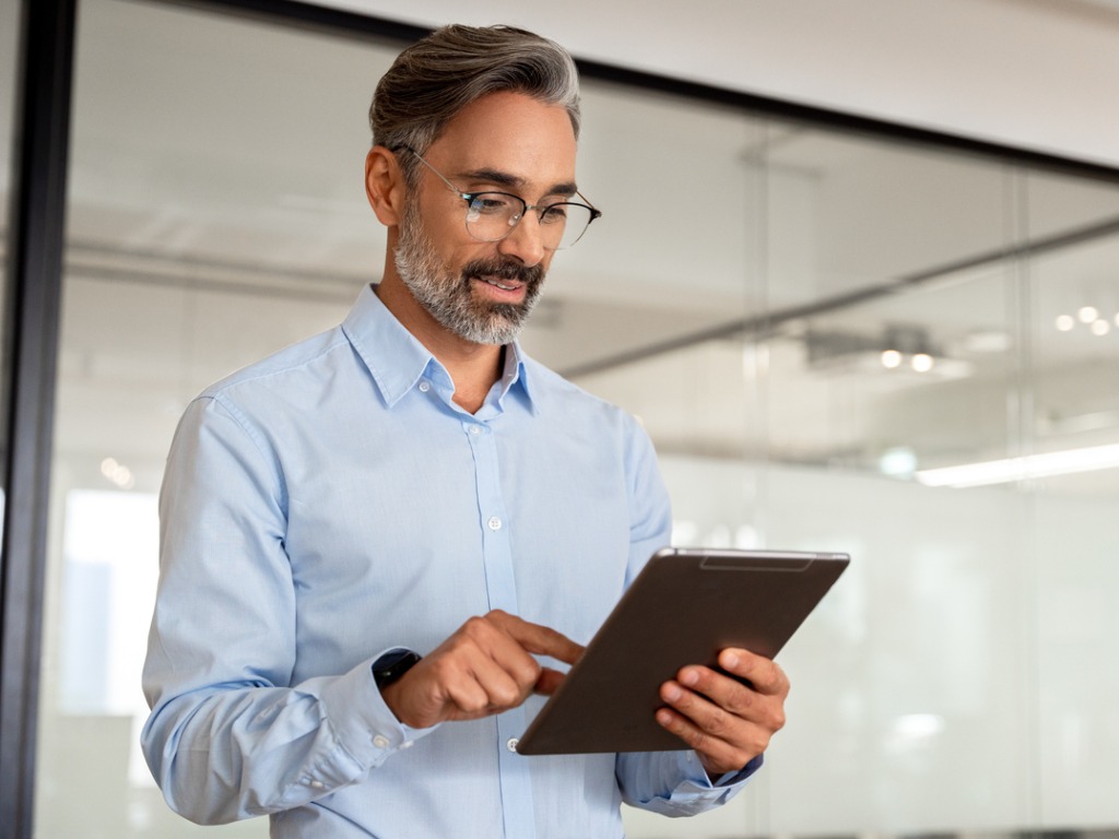 Professional businessman using a tablet to search for job opportunities